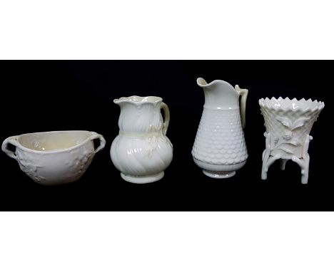 Belleek Porcelain - Four items comprising a ribbon shape cream jug, yellow tint, 1st green mark 1946 - 1955; a fish scale cre