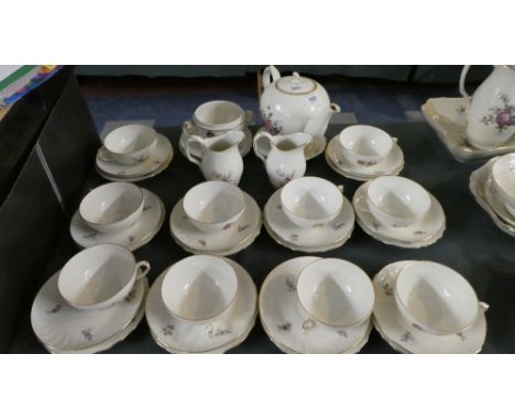 A Rose Patterned Tea Service by Copenhagen Denmark, Comprising Ten Trios, Teapot, Sugar Bowl, Two Cream Jugs etc