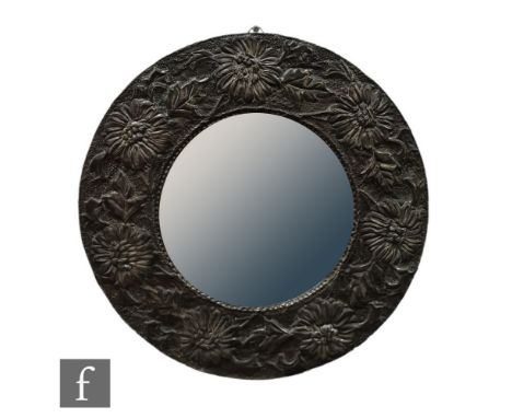 Unknown - An Arts &amp; Crafts pewter convex wall mirror, the central domed mirror plate encircled with a hammered pewter fra