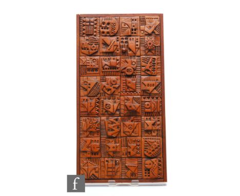 Ron Hitchins - A later 20th Century framed terracotta tile panel, formed of thirty two tiles decorated with geometric abstrac