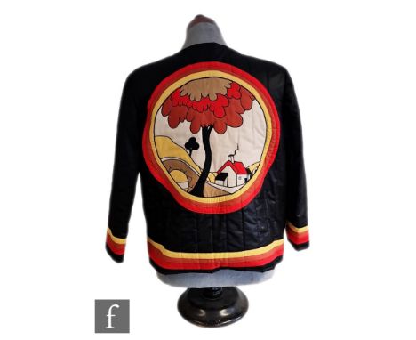After Clarice Cliff - A late 20th Century hand made quilted jacket with an image of a House &amp; Bridge charger in applique 
