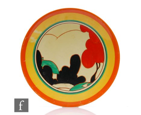 Clarice Cliff - Red Autumn - A circular dish form plate circa 1931, hand painted with a stylised tree and cottage landscape w