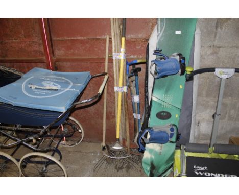 A quantity of  long handled gardening tools to include rakes, garden shears etc.