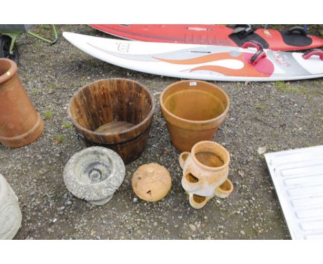 A terracotta strawberry planter, another terracotta planter, a wooden planter etc