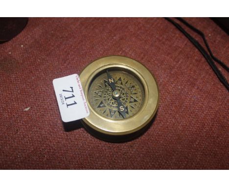 A reproduction brass combined compass and magnifying glass (90)