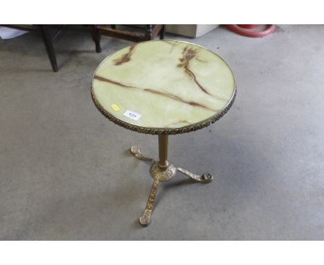 A metal framed table raised on tripod base with simulated onyx top