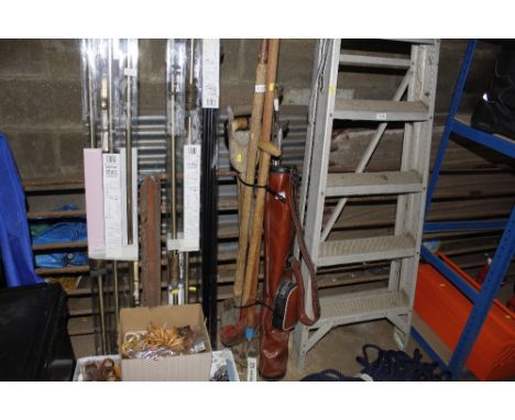 A bundle of long handled gardening tools