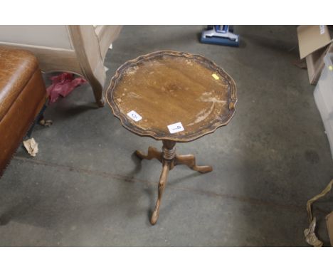 A wine table raised on tripod base