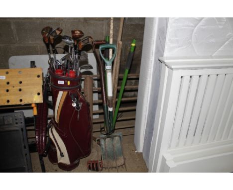 A bundle of long handled gardening tools to include rake, fork, spade etc.