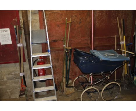 A quantity of long handled gardening tools to include scythe, rake, spade etc.
