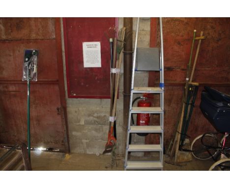 A bundle of long handled gardening tools