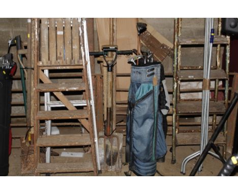 A bundle of long handled gardening tools