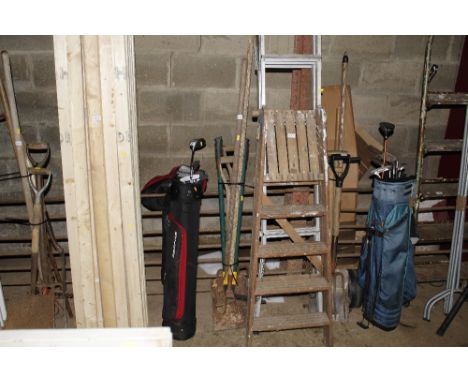 A bundle of long handled gardening tools