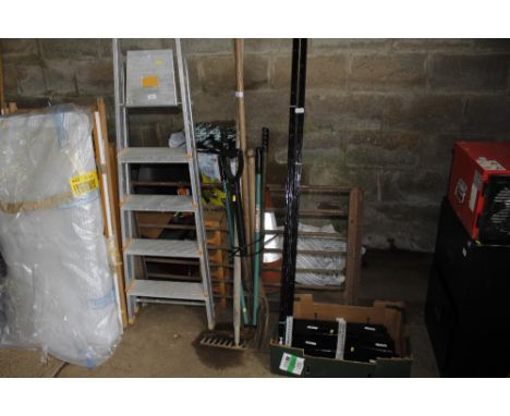 A bundle of long handled gardening tools to include edging shears, rake, fork, spade