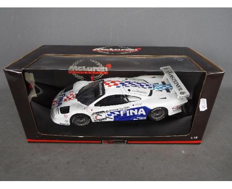 UT Models - McLaren F1 GTR in 1:18 scale # 39710. This model has a broken left door hinge and a detached mirror which is stil