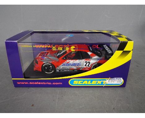 Scalextric - Nissan Skyline GTR # C2637 in Xanavi Nismo livery. The car appears Mint in a Near Mint box with only minor stora