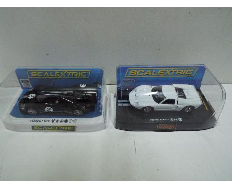 Scalextric - Ford GT40 # C2473 in plain white finish and Ford GT GTE Heritage Edition # C4063 in black. Both cars appear Mint