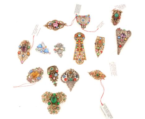 Fourteen 1930's Czechoslovakian small paste set dress clips and brooches, multi-coloured paste gems set into filigree white a