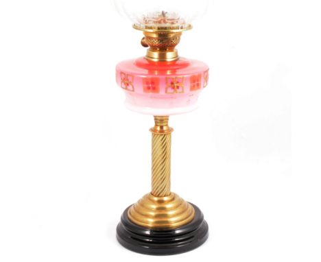 A Victorian brass oil lamp, pink tinted reservoir, shade etched with floral pattern, 67cm.