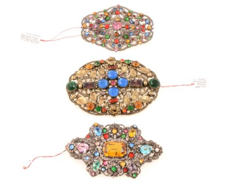 Three large 1930's filigree brooches with coloured paste gems, Czechoslovakian, a large fine quality oval gilt metal brooch, 