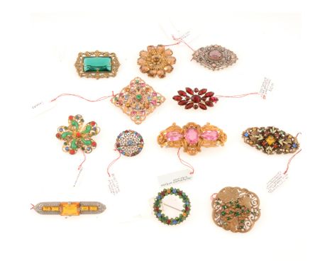 Twelve vintage Czechoslovakian coloured paste brooches, circa 1930, a gilt metal filigree brooch set with three faux pink top