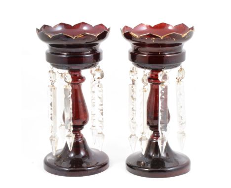 Pair of ruby tinted glass lustre glasses, with prismatic drops, 32cm.
