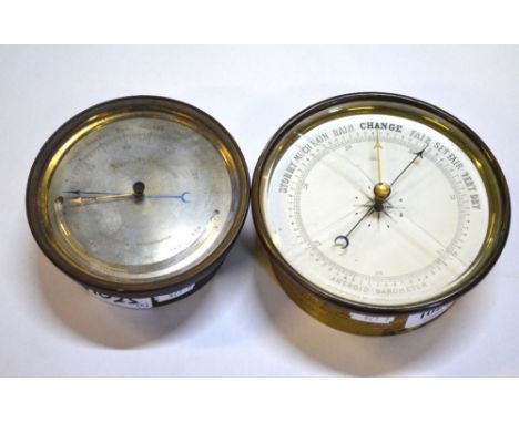 A 19th century aneroid barometer, the silvered dial with carved mercury thermometer, in brass drum case, 12 cm diameter, to/w