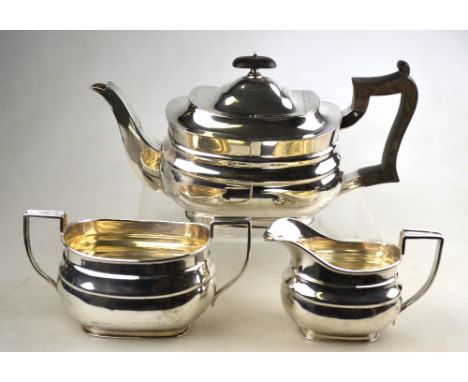A heavy quality silver three piece tea service of oblong form with composite handle and finial, William Hutton & Sons Ltd., S
