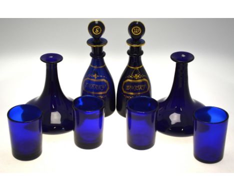 A pair of early 19th century Bristol blue mallet-shaped decanters each with single plain neck ring and target stopper, gilded