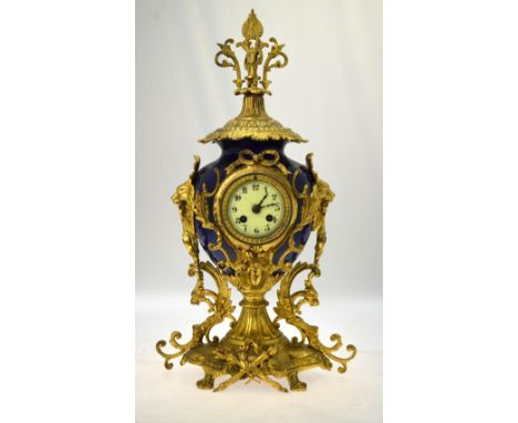 A late 19th /20th century eight-day two train cylinder movement mantel clock within an ormolu mounted blue porcelain bowl bod