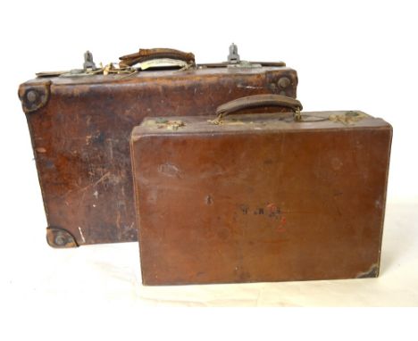 A vintage crocodile suitcase, the fitted interior with green moire silk lining, to/w two small vintage leather suitcases (3) 