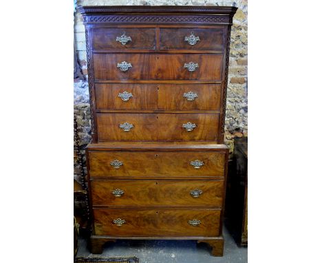 A George III mahogany chest on chest, the Greek-key moulded canopy over a blind fret frieze, two short over three-long gradua