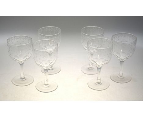 A set of six vintage wine glasses, the bowl etched with stars and a foliate band, having a faceted stem and plain foot, 15 cm