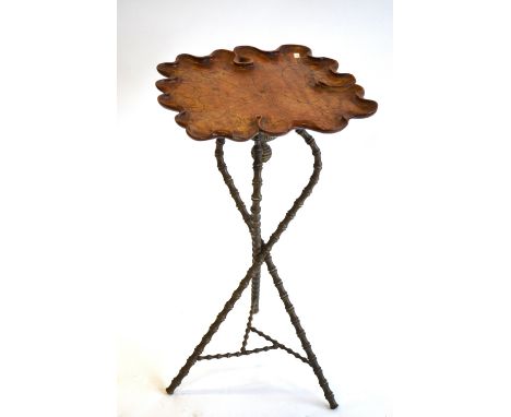 A 19th century carved and moulded walnut organic form tripod table, raised on a brass frame originally components of an oil l