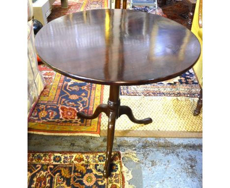 An 18th century mahogany tripod table, the circular top over a birdcage and tapering turned column to pad feet, 75 cm diam x 