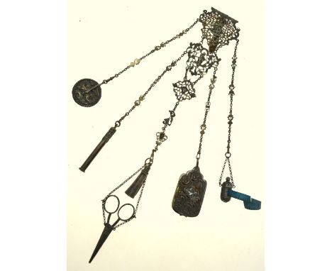 A Victorian electroplated chatelaine, hung with a tape measure, ivory-leaf notebook, wheel pin-cushion, propelling pencil, sc