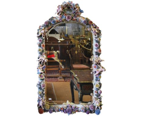 A large Sitzendorf porcelain bevel glass wall mirror, the sectional frame profusely decorated in bold relief with flowers, fo