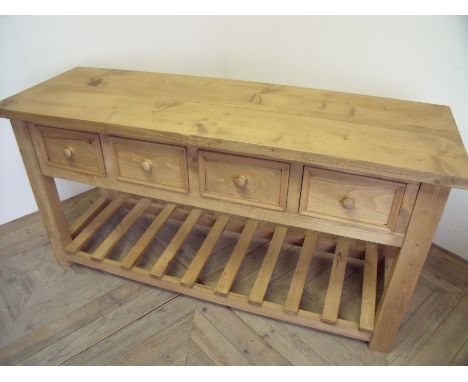 Pine side table with four drawers and slated under tier on square supports (51cm x 153cm x 78cm) 