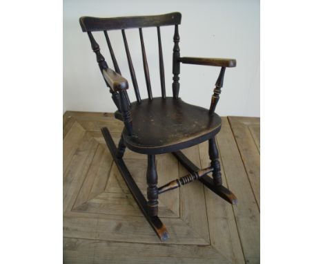 19th C child's stick back Windsor style rocking chair on turned supports and traces of painted detail