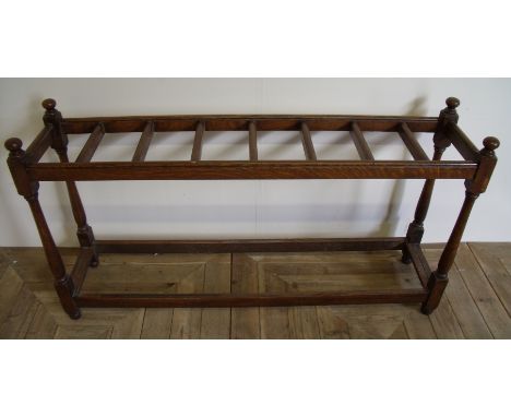 Late Victorian oak rectangular multi section stick stand on turned supports (130cm x 30cm x 70cm)