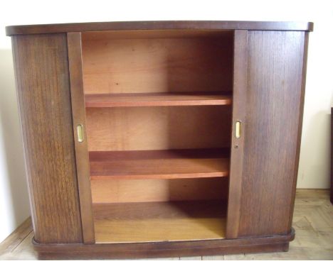 1920s oak two tier central cabinet with two wrap around roller shutter doors (122cm x 46cm x 102cm)