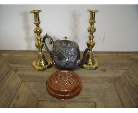 Victorian embossed silver plated teapot, a magnifying loupe, embossed jelly type mould and a pair of 19th C brass push candle