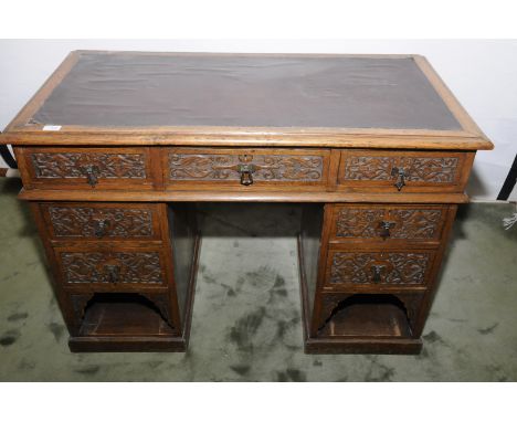 Edwardian light oak twin pedestal desk with inset panel to the top, central drawer and three drawers and open base to each pe