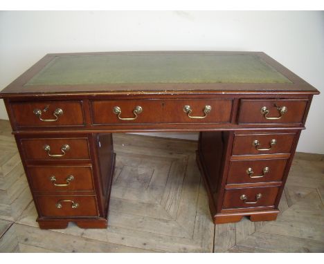 Modern mahogany twin pedestal desk with green leather insert top with three drawers above three drawers to each pedestal (122