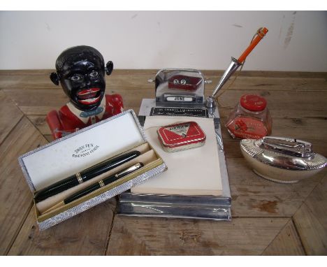 Cased Swan pen and pencil set, Ronson table lighter, metal money bank and an early/mid 20th C chrome desk note pad and calend
