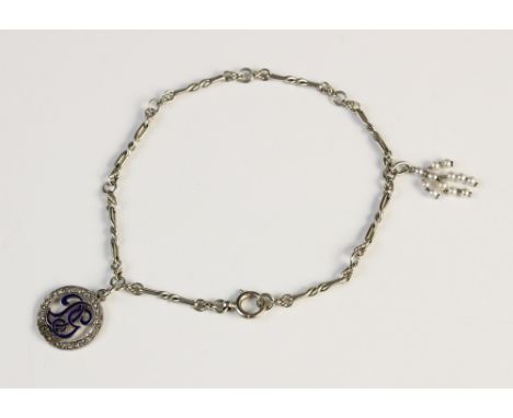 An early 20th century diamond and enamel charm, of circular form with initials 'DG' to centre decorated with blue enamel with