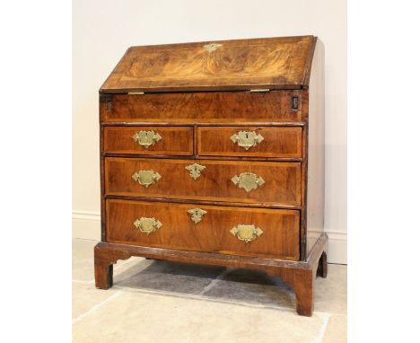 A William and Mary burr walnut bureau, the cross banded fall front, enclosing a compartmentalised interior with waterfall dra