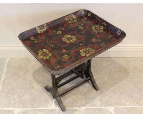 A late Victorian papier mache tray top folding table, the galleried tray applied with floral decoration upon a black ground, 