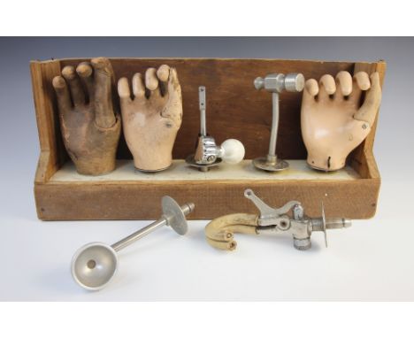 A leather and metal prosthetic forearm, early 20th century, the tip set with a locking mechanism to accept a range of prosthe