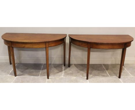 A pair of George III mahogany demi-lune side tables, each with ebonised inlay, on legs of square section, 73cm H x 131cm W x 